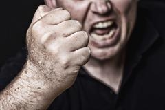 Man with his fist raised - New York Assault Attorney